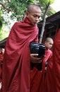 Myanmar monk carrying meal's bowl