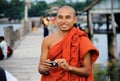 Myanmar monk taking a photo to a tourist