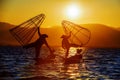 Myanmar, Inle lake Intha fisherman on boat at amazing sunset