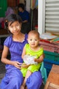 Myanmar Travel Images teenage girl and her small sister both with traditional thanaka on their faces