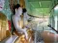 Myanmar, Sagaing Hill, Pagoda U Min Thonze with gilded Buddha images seated in crescent-shaped colonnade