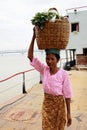 Myanmar woman carrying a basket on her head