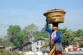 Myanmar woman carrying basket on her head. Royalty Free Stock Photo