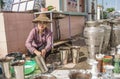 A Myanmar woman washing silver vases for monks at Ananda Chedi Monastery in Taunggyi, Myanmar