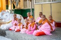 Myanmar, Yangon, November 2019, Shwedagon Pagoda, children Buddhist monks with shaved heads sit at the pagoda during a religious