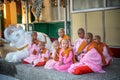 Myanmar, Yangon, November 2019, Shwedagon Pagoda, children Buddhist monks with shaved heads sit at the pagoda during a religious