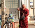 Myanmarese Buddhist Monks on the daily alms round, walking on the footpath in the morning at Yangon