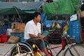 Myanmarese man sitting on his bicycle tricycle taxi for waiting passenger at the market in Yangon