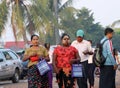 Myanmese woman with thanakha Myanmar powder on her face carry the bag to going to the market in the morning at Yangon