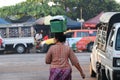 Myanmese woman with thanakha Myanmar powder on her face put the plastic basket on her head, from going to market