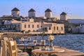 Myconos Greece View from a terrace at the sea on the windmills on a sunny day at sunset. A bright blue sea, and sky. Royalty Free Stock Photo