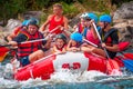 Rafting. A cheerful group descends on a large inflatable boat on the river. There is a child in the boat