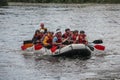 Group of happy people with guide whitewater rafting and rowing on river, extreme and fun sport Royalty Free Stock Photo