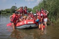 Group of happy people with guide whitewater rafting and rowing on river, extreme and fun sport Royalty Free Stock Photo