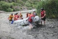 Group of happy people with guide whitewater rafting and rowing on river, extreme and fun sport Royalty Free Stock Photo