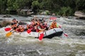 Group of happy people with guide whitewater rafting and rowing on river, extreme and fun sport Royalty Free Stock Photo