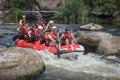 Group of happy people with guide whitewater rafting and rowing on river, extreme and fun sport Royalty Free Stock Photo