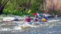 Rafting. Three sportsmen are sailing on a rubber inflatable boat. Teamwork. Water splashes close-up. Ecological tourism Royalty Free Stock Photo
