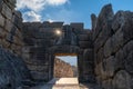 View of the Lion Gate entrance portal at the ancient citadel of Mycenae with a morning sunburst