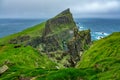 Mykines island cliffs under misty cloudy day