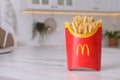 MYKOLAIV, UKRAINE - AUGUST 12, 2021: Big portion of McDonald`s French fries on marble table in kitchen. Space for text