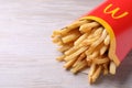 MYKOLAIV, UKRAINE - AUGUST 12, 2021: Big portion of McDonald`s French fries on white wooden table, closeup. Space for text
