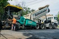 MYKOLAIV, UKRAINE - AUGUST 04, 2021: Worker with road repair machinery laying new asphalt