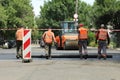 MYKOLAIV, UKRAINE - AUGUST 04, 2021: Workers with road repair machinery laying new asphalt