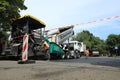 MYKOLAIV, UKRAINE - AUGUST 04, 2021: Workers with road repair machinery laying new asphalt