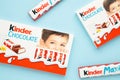 Mykolaiv, Ukraine - July 28, 2023: Kinder chocolate bars on blue background. Kinder bars are produced by Ferrero founded in 1946