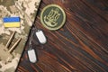 MYKOLAIV, UKRAINE - SEPTEMBER 19, 2020: Flat lay composition with Ukraine military equipment on wooden table, space for text