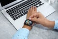 MYKOLAIV, UKRAINE - SEPTEMBER 19, 2019: Woman using Apple Watch at table, closeup Royalty Free Stock Photo