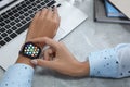 MYKOLAIV, UKRAINE - SEPTEMBER 19, 2019: Woman using Apple Watch at grey table, closeup Royalty Free Stock Photo