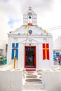 Mykonos, Greece - 17.10.2018: Agia Kyriaki Church, typical Greek church white building with red dome against the blue Royalty Free Stock Photo