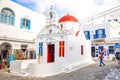 Mykonos, Greece - 17.10.2018: Agia Kyriaki Church, typical Greek church white building with red dome against the blue Royalty Free Stock Photo