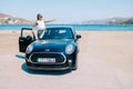 Mykonos Greece April 2018, woman on a road trip,Mini car on the beach during road trip Mykonos