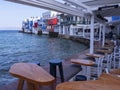 Panoramic view of the sights of the island of Little Venice with walking tourists in Mykonos, Greece. Royalty Free Stock Photo