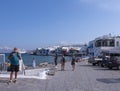 Panoramic view of the sights of the island of Little Venice with walking tourists in Mykonos, Greece. Royalty Free Stock Photo