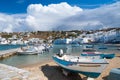 Speed boats on sea beach in Mykonos, Greece. Sea village with white houses on mountain landscape. Summer vacation on