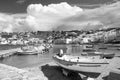 Speed boats on sea beach in Mykonos, Greece. Sea village with white houses on mountain landscape. Summer vacation on