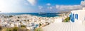Mykonos, Greece - 17.10.2018: Panoramic view over Mykonos town with white architecture and cruise liner in port, Greece Royalty Free Stock Photo