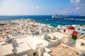 Mykonos, Greece - 17.10.2018: Panoramic view over Mykonos town with white architecture and cruise liner in port, Greece Royalty Free Stock Photo