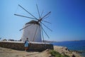 Mykonos, Greece, 7 September 2018, A beautiful tourist have a picture taken near a windmill in Chora Royalty Free Stock Photo