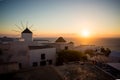 Mykonos, Greece. Sunset over the sea with iconic windmills of the Greek island of the Mikonos, seen from terrace Royalty Free Stock Photo