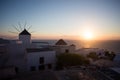 Mykonos, Greece. Sunset over the sea with iconic windmills of the Greek island of the Mikonos, seen from terrace Royalty Free Stock Photo