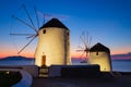 Mykonos, Greece. Traditional windmills. The symbol of Mykonos during sunset. Landscape during sunset. Sea shore and beach. Royalty Free Stock Photo