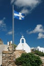 Mykonos Island - Greece. White Wash Chapel and Greek Flag Royalty Free Stock Photo