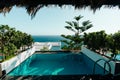 Mykonos luxury hotel: View of Patio deck with infinity pool and bay. Afternoon shot of luxury home. Royalty Free Stock Photo