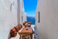 Benches with pillows in a typical Greek bar in Mykonos town with sea view, Cyclades islands, Greece Royalty Free Stock Photo
