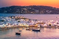 Mykonos port with boats and windmills at evening, Cyclades islands. Royalty Free Stock Photo